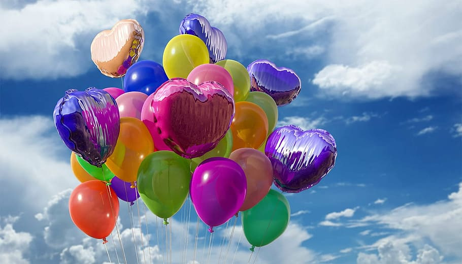 Colorful balloons against a cloudy sky